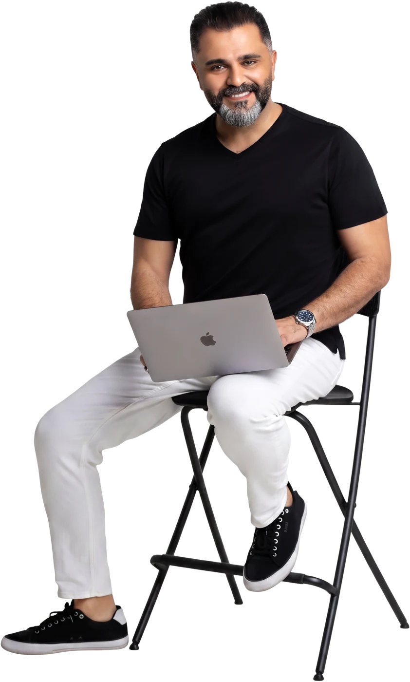 Alaa Hassan, founder of Red Goat Digital, seated with a laptop
